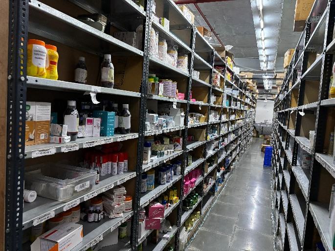 Long pick aisle between stocked shelves
